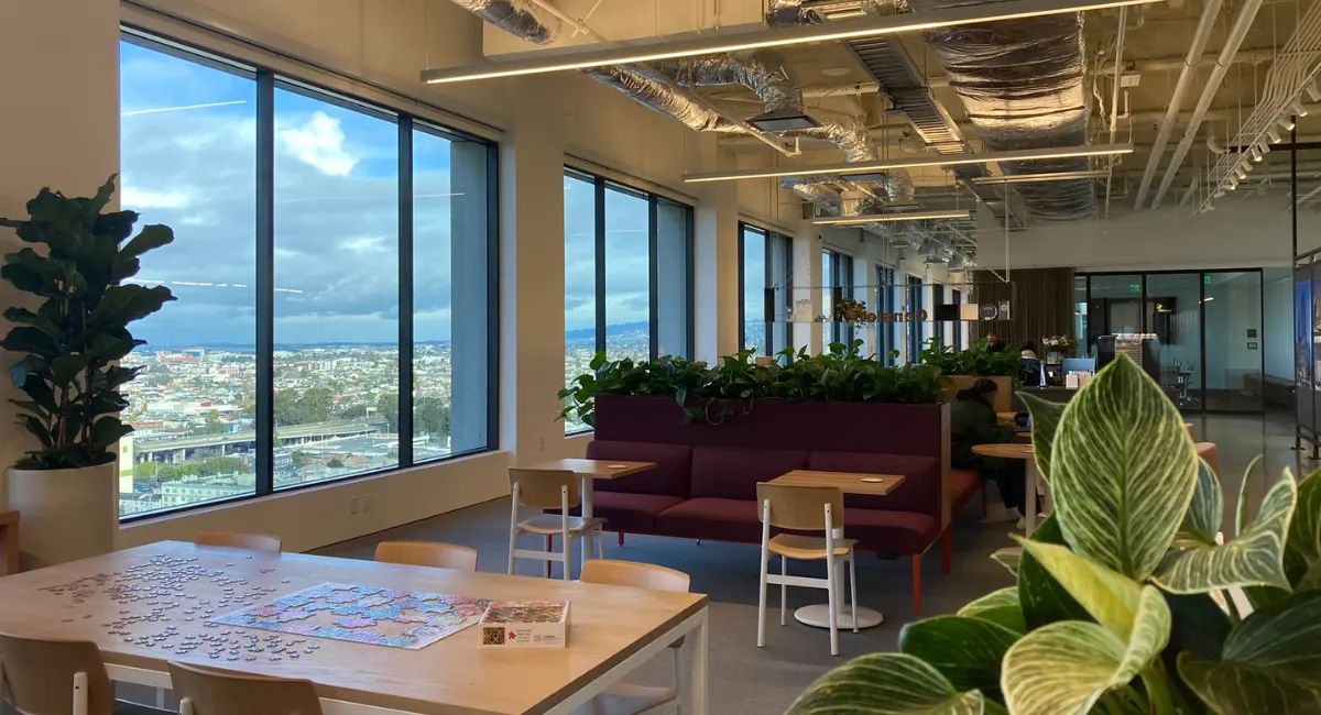 an office with a view of the city with plants