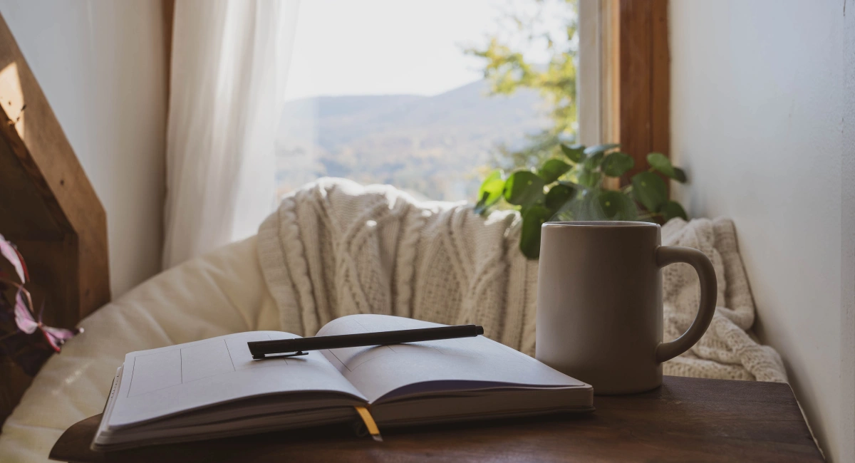 image-banner-stock-cozy-window-nook-with-open-journal-and-coffee-1353475989.webp