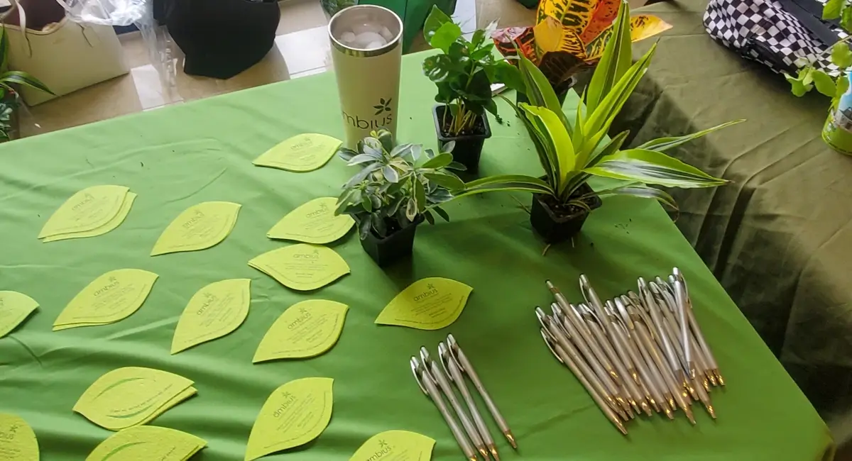Table with Ambius notepads and pens