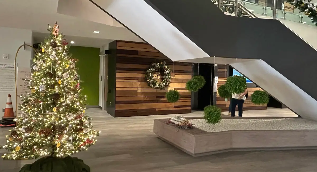 Christmas tree and wreath under stairs
