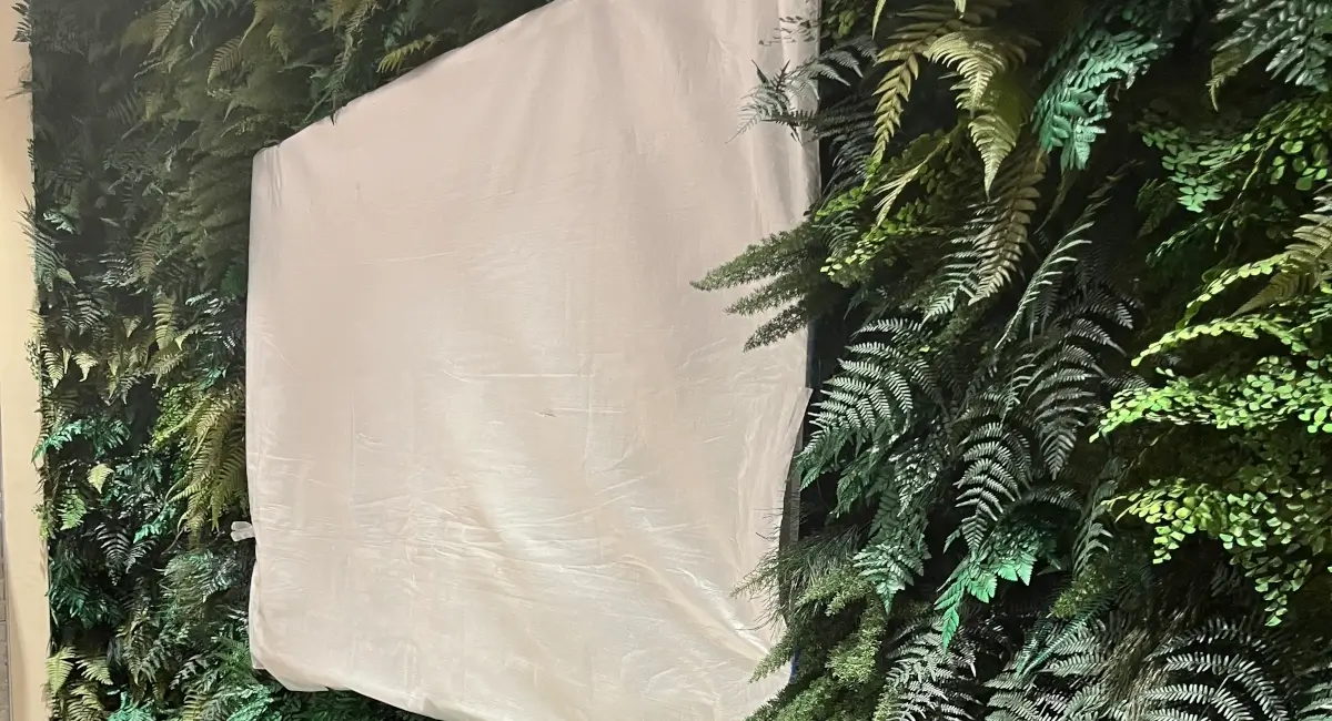 Detailed view of various fern species and textures in a professional indoor vertical garden installation.