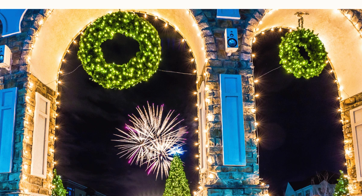 60" holiday wreaths lit up and hanging from an ampitheater archway.
