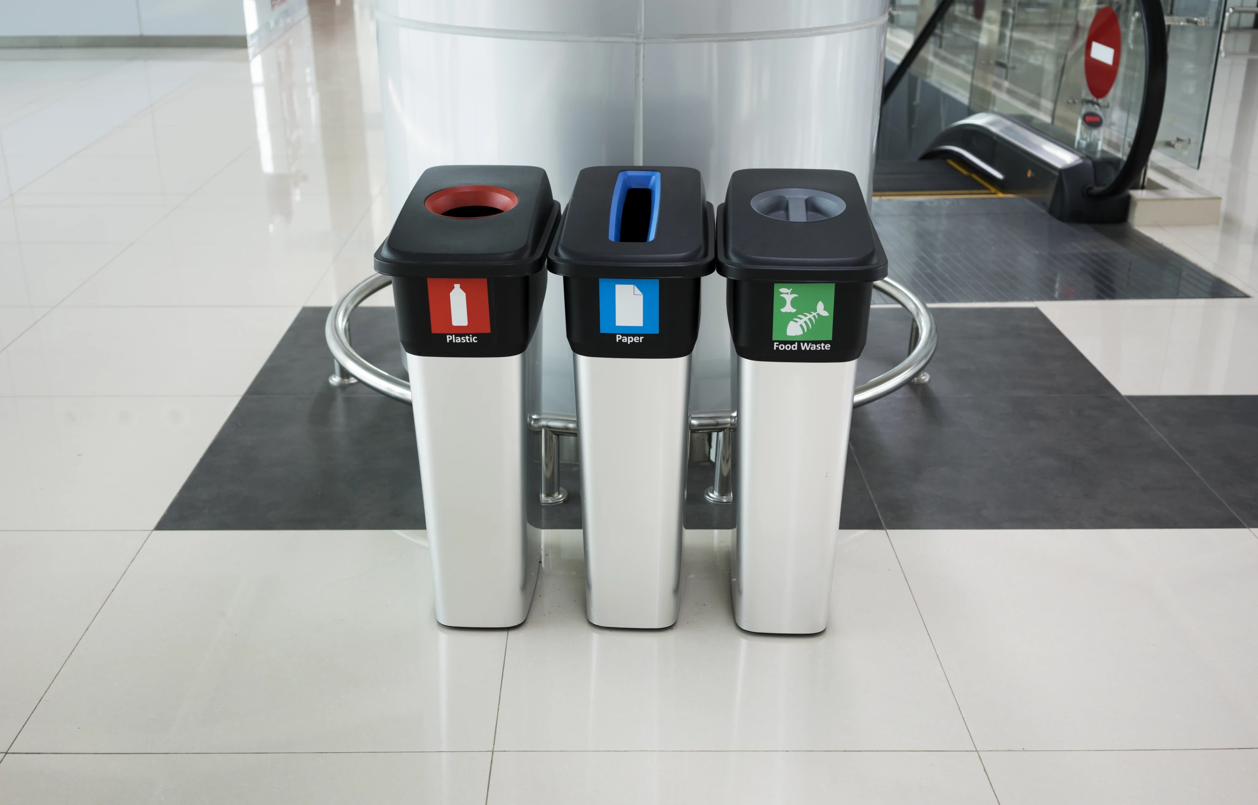 three trash cans in the airport