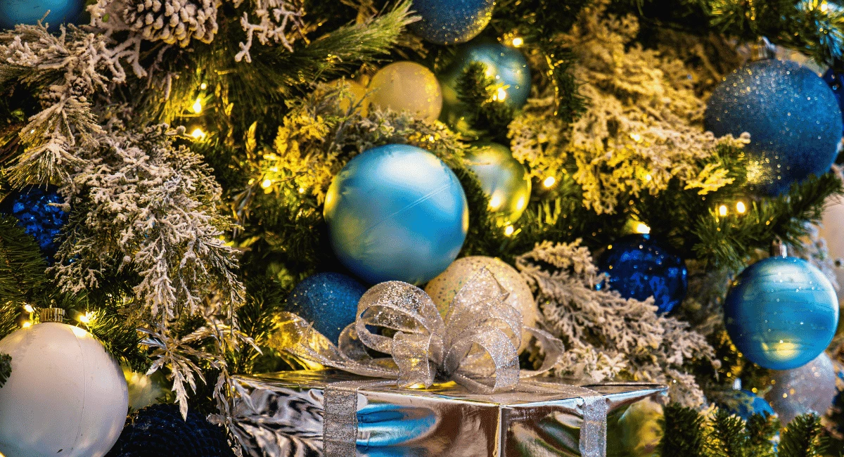 The Enchanted Forest design trend displayed on a tree and wrapped gifts.