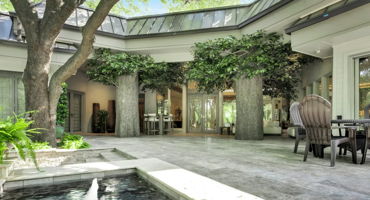 Lifelike artificial trees add to this residential client's exterior canopy.