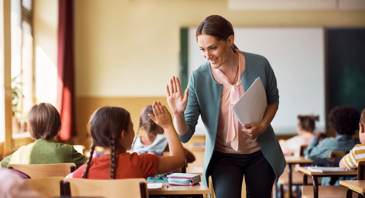 image-banner-stock-happy-teacher-and-schoolgirl-giving-high-five-1410336912.webp