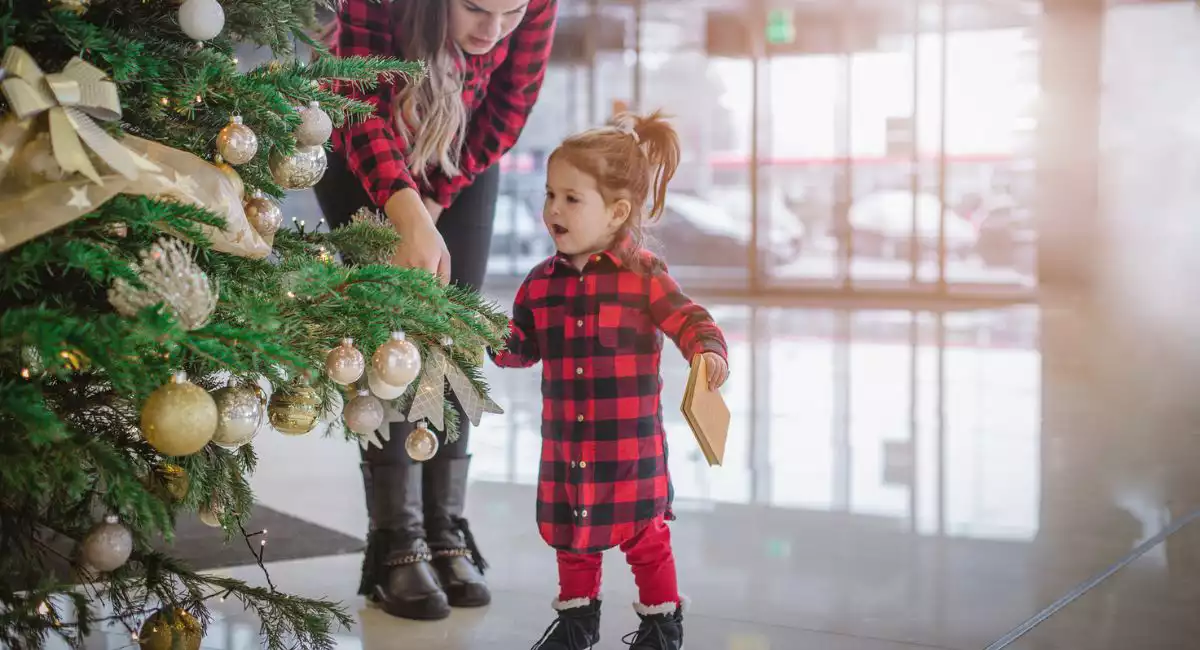 Young child with Christmas tree