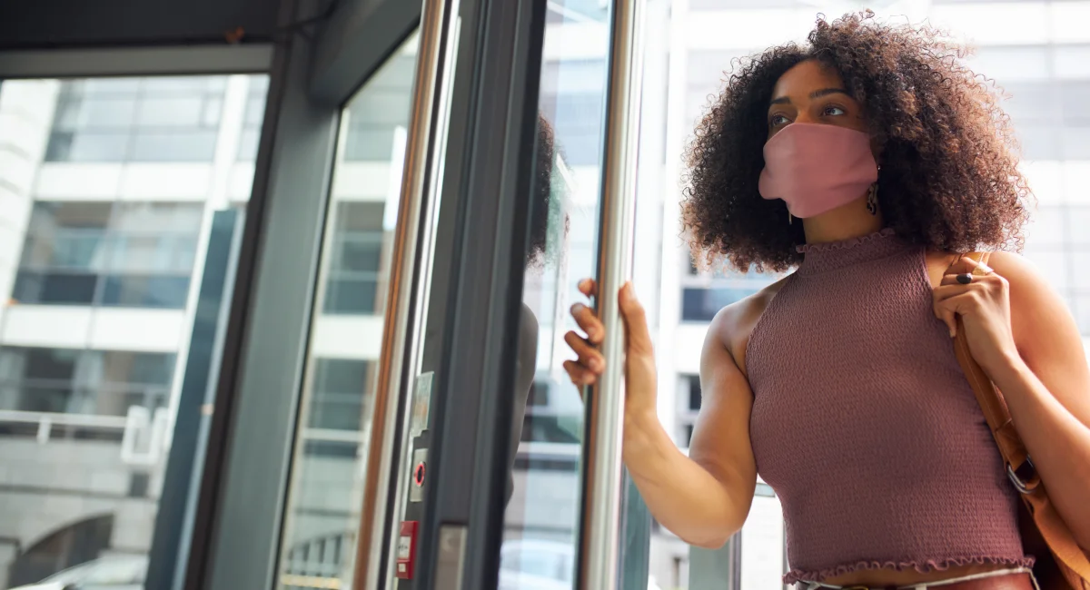 image-banner-stock-young-adult-woman-entering-office-wearing-face-1272585655.webp