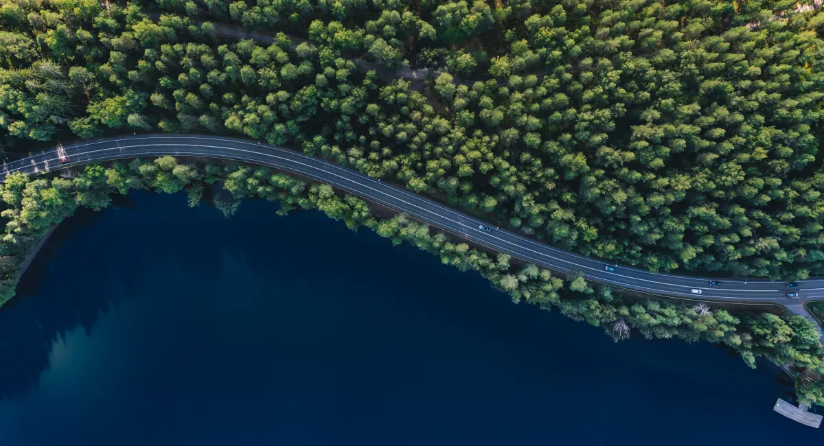 image-banner-stock-aerial-view-of-road-with-green-woods-by-blue-1462646898.webp