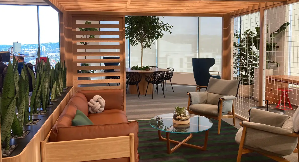 a office space filled with furniture and plants
