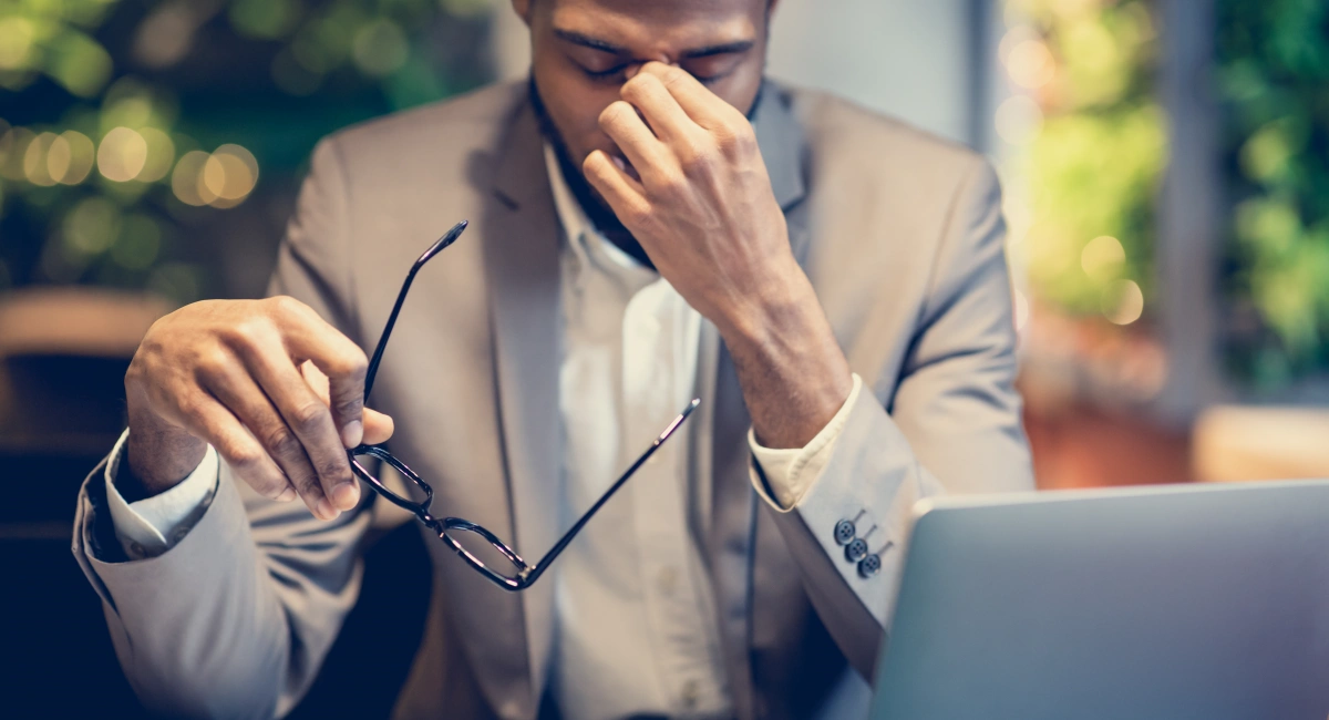 image-banner-stock-exhausted-afro-manager-massaging-nose-sitting-at-1208529830.webp