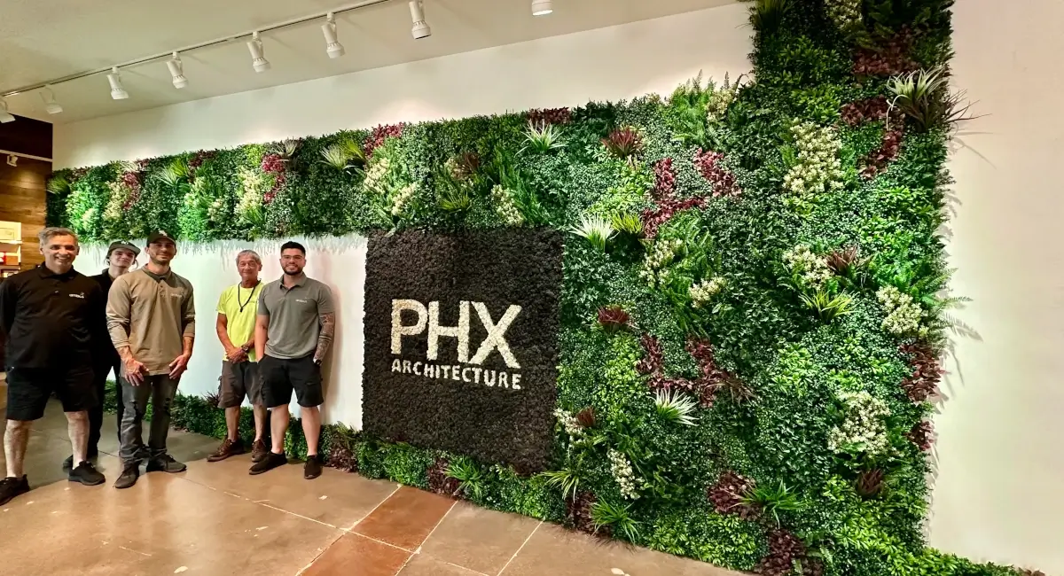 Colleagues next to PHX Architecture Green Wall