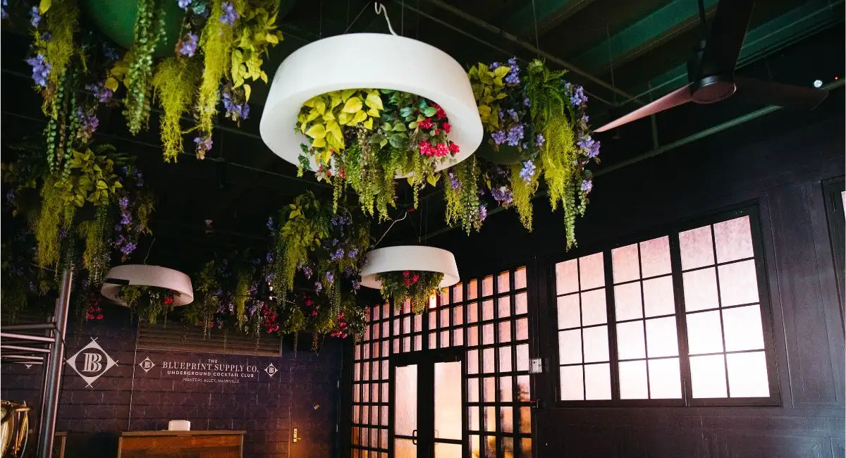 Replica plants on ceiling and lights