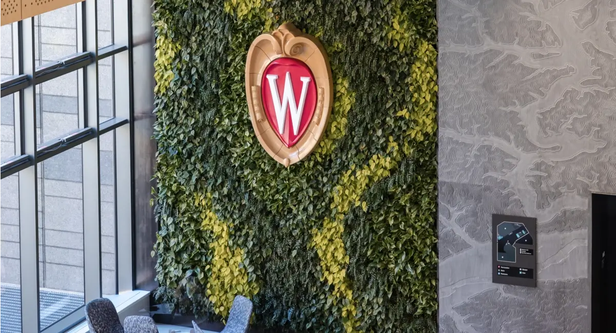 Large living green wall featuring the University of Wisconsin "W" crest.