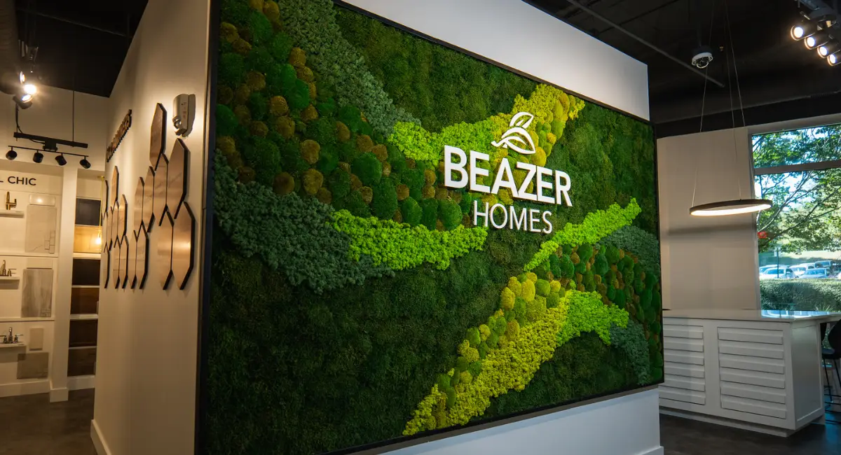 A large, complex moss wall with a client logo on it in a business hub.