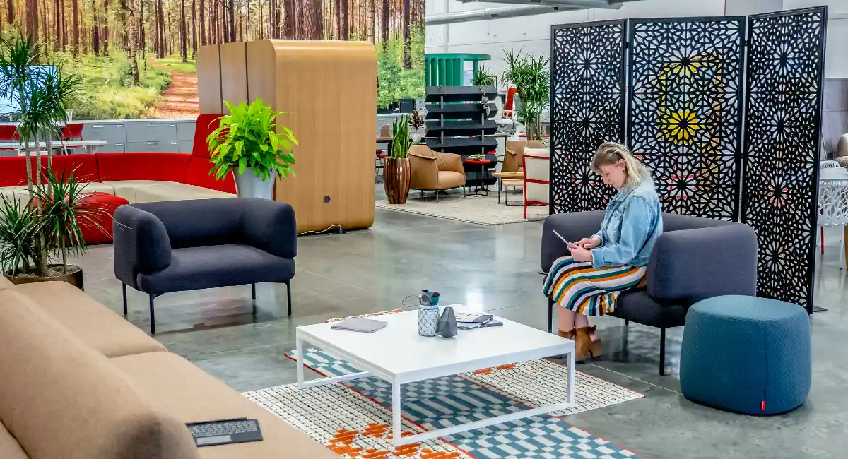 Woman sitting in sitting area looking at a tablet