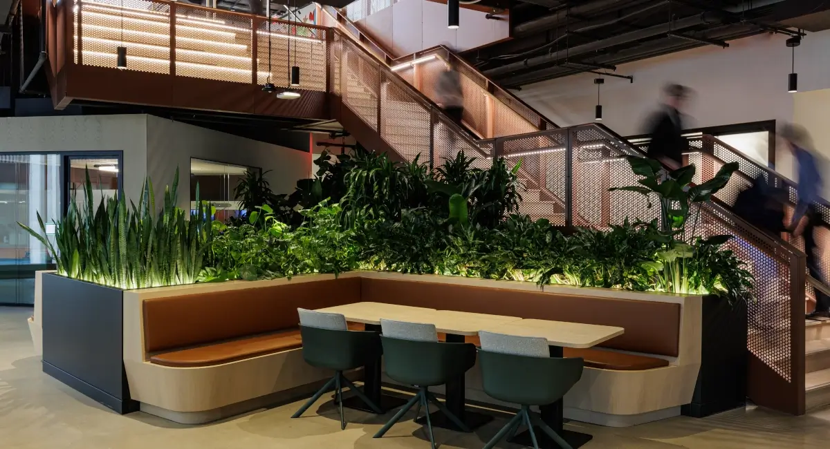 Seating area with trough of live plants near stairs