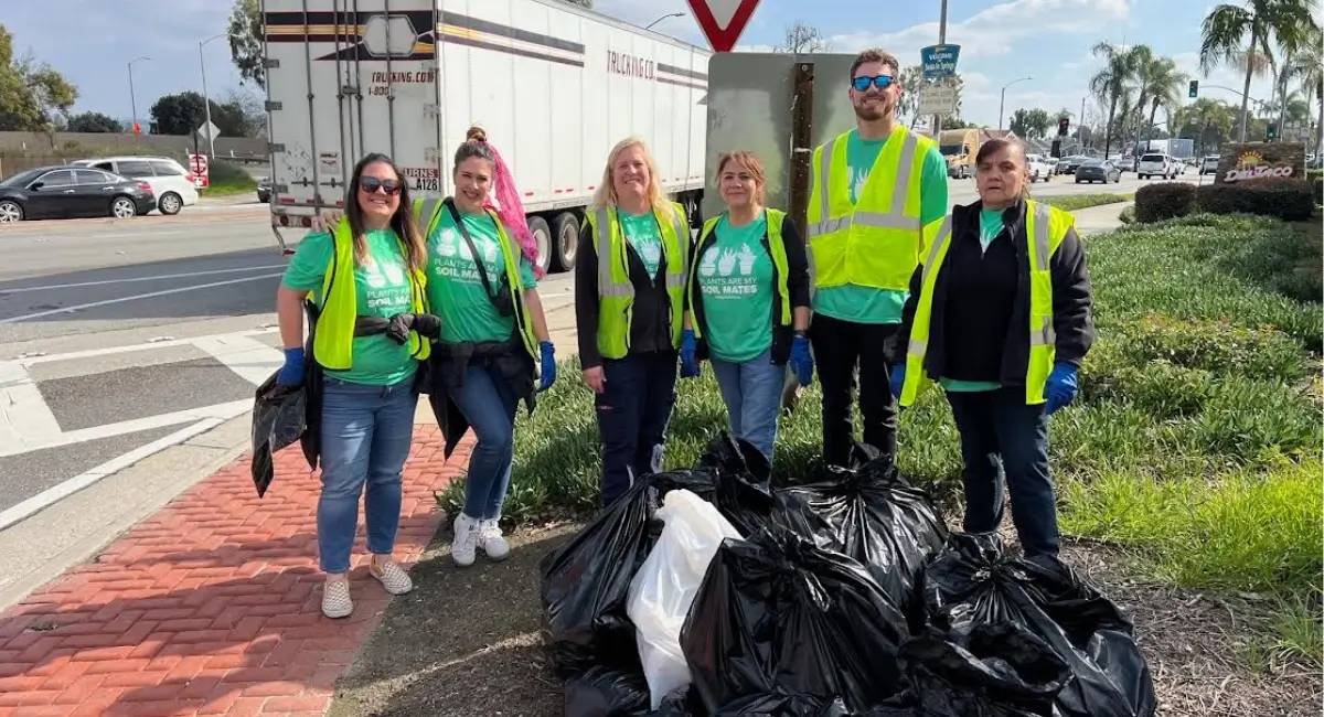 Ambius colleagues in front of trash cans during Earth Day cleanup event