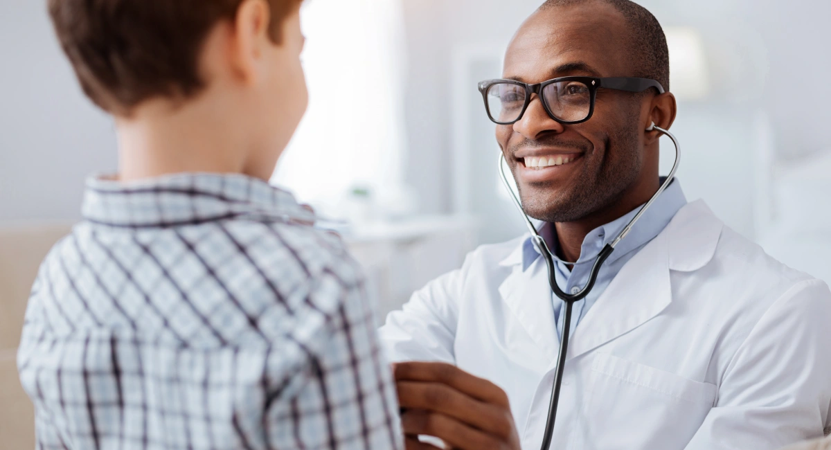 image-banner-stock-afro-american-male-doctor-examining-boys-938437262.webp