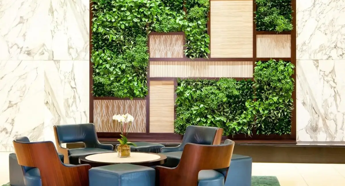 a living wall of green plants in a seating area