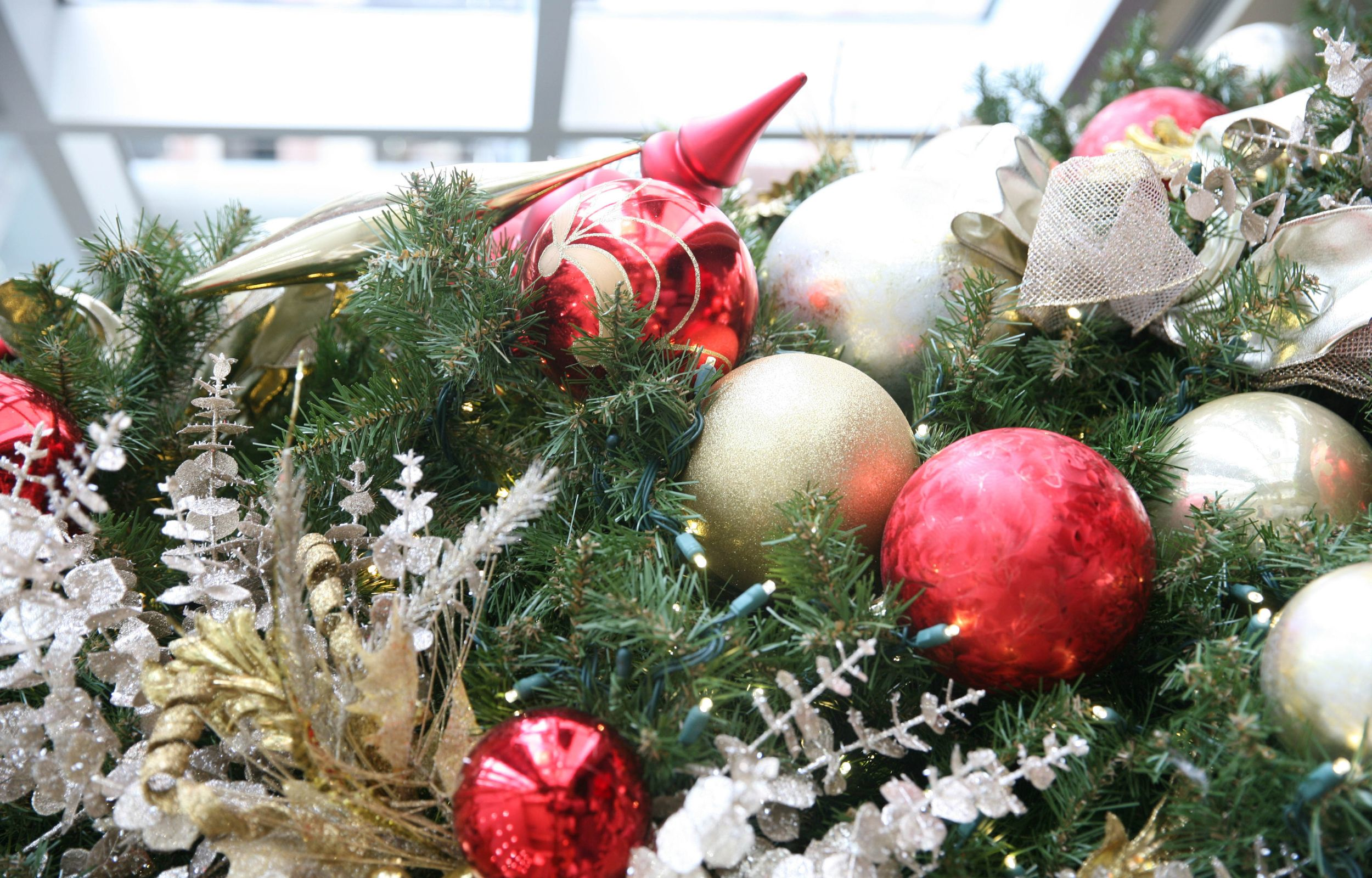 Image of red and gold ornaments on a Christmas tree