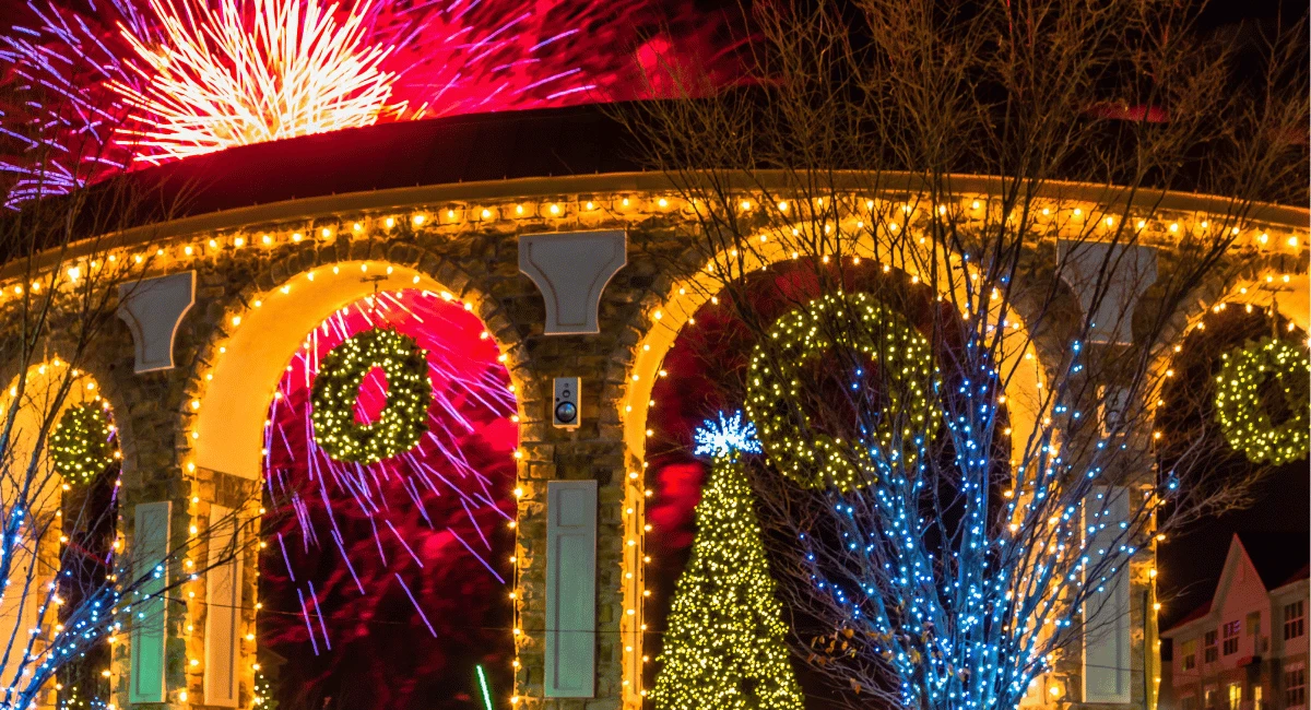 60" beautifully lit wreaths hang from the ampitheater arches as fireworks burst in the background.
