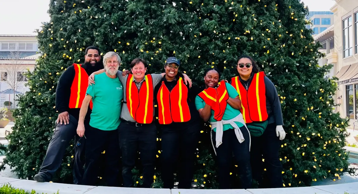 Ambius employees in front of Christmas tree